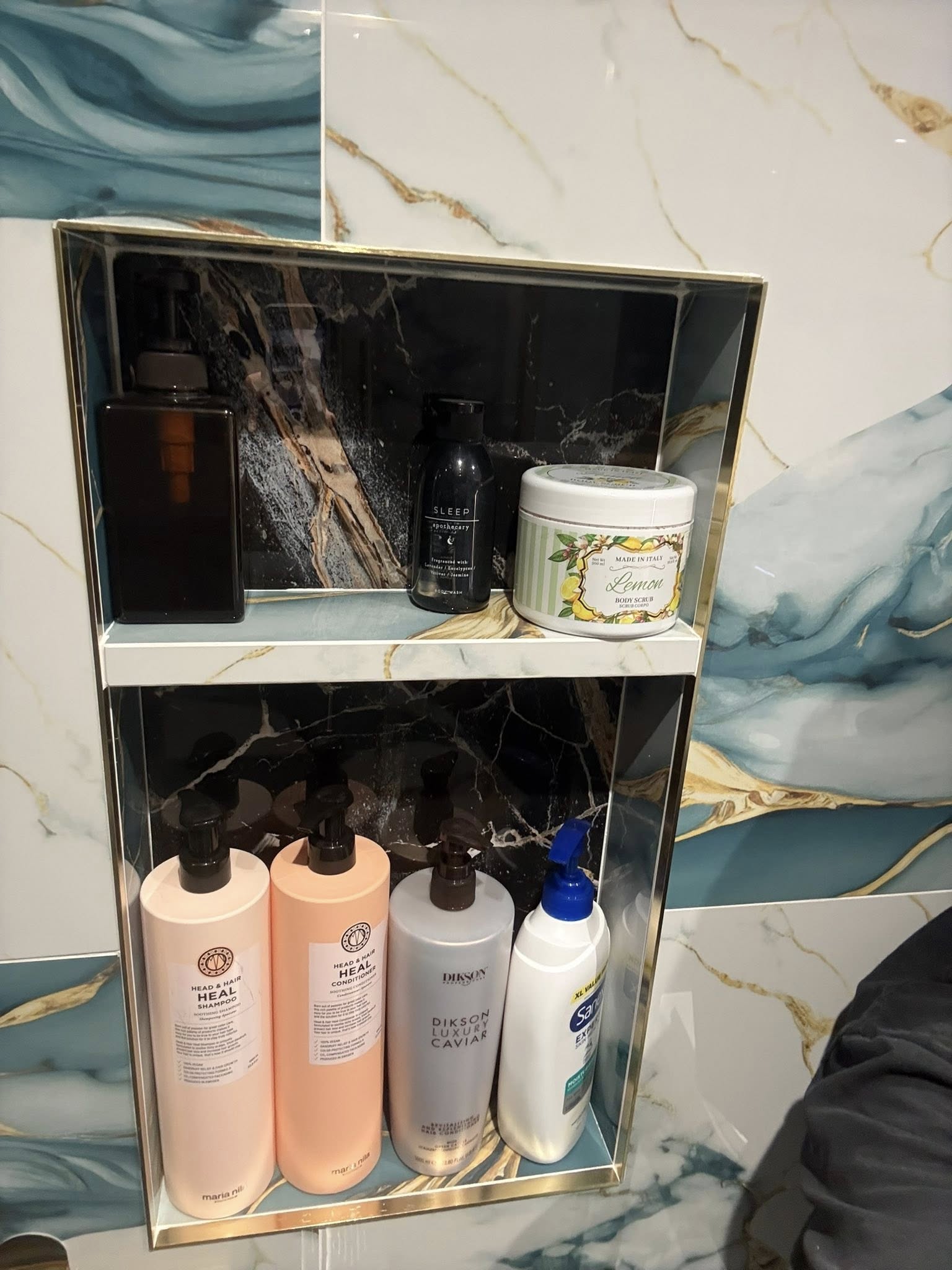 Close-up of the brushed gold taps and black vanity