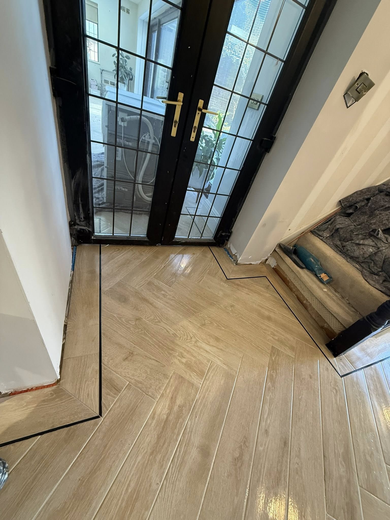 Close-up of precision herringbone tile installation